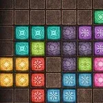 Barevný mozaikový vzor složený z různých geometrických bloků na hnědém mřížkovaném pozadí