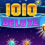 Barevný nápis 1010 DELUXE na tmavém pozadí s hvězdami a zářícími drahokamy
