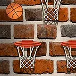 Basketbalový míč a tři basketbalové koše na cihlové zdi