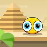 Žlutá kulatá postava s velkýma modrýma očima stojí před pyramidami na pozadí s pouštní scenérií
