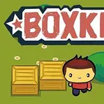 Postavička s červeným tričkem stojí vedle dřevěných beden na zeleném pozadí s nápisem BOXKID nahoře