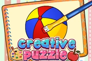 Barevný míč je malován štětcem na stránce poznámkového bloku s nápisem Creative Puzzle