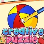 Barevný míč je malován štětcem na stránce poznámkového bloku s nápisem Creative Puzzle