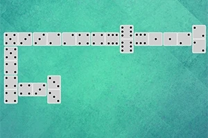 Domino kostky uspořádané do tvaru písmene L na zeleném pozadí