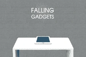 Tablet ležící na bílém stole před šedou cihlovou zdí s nápisem Falling Gadgets