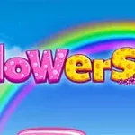 Barevný nápis flowers s duhou v pozadí na modré obloze