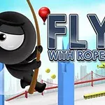Černá postavička na laně v městském prostředí s výrazným nápisem FLY WITH ROPE 2