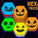 Hexa Sort Trick or Treat Barevné šestiúhelníky s vyřezávanými obličeji připomínajícími dýně a kostlivce vedle ukazující ruky na fialovém pozadí