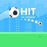 Fotbalový míč letící směrem k brance s nápisem Hit the Crossbar na pozadí městských budov