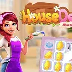 Mladá žena s červenými vlasy drží štětec vedle herní tabulky se zlatými mincemi a dalšími barevnými prvky, s nápisem House Design Match 3 nahoře