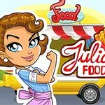 Žena s hnědými vlasy stojí před food truckem s burgerem a hranolky, s nápisem Julias Food Truck