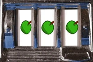 Tři zelená jablka zarovnaná vedle sebe v hracím automatu