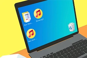 Na obrázku je laptop s modrou obrazovkou, kde jsou ikony dvou hudebních souborů, textového dokumentu a koše