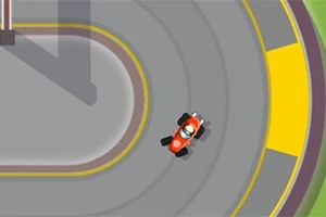 Červené auto projíždí zatáčkou na závodní trati z ptačí perspektivy