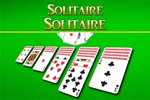 Hromádky hracích karet na zeleném podkladu s nápisem Solitaire nahoře