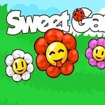 Nápis Sweet Garden s beruškou a čtyřmi usměvavými květinami různých barev na zeleném trávníku s modrým oblohou v pozadí