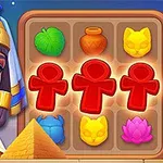 Žena ve stylu starověkého Egypta vedle herního pole s různými barevnými symboly