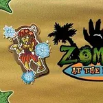 Kreslený zombie v havajském oblečení obklopený sněhovými vločkami vedle palem a textu Zombies at the Beach s černou siluetou ruky na pozadí písku